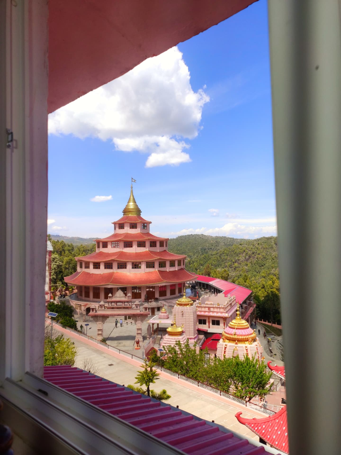 The multi-tiered pagoda temple and gold-domed shrines of Shri Kalyanika Dol Ashram