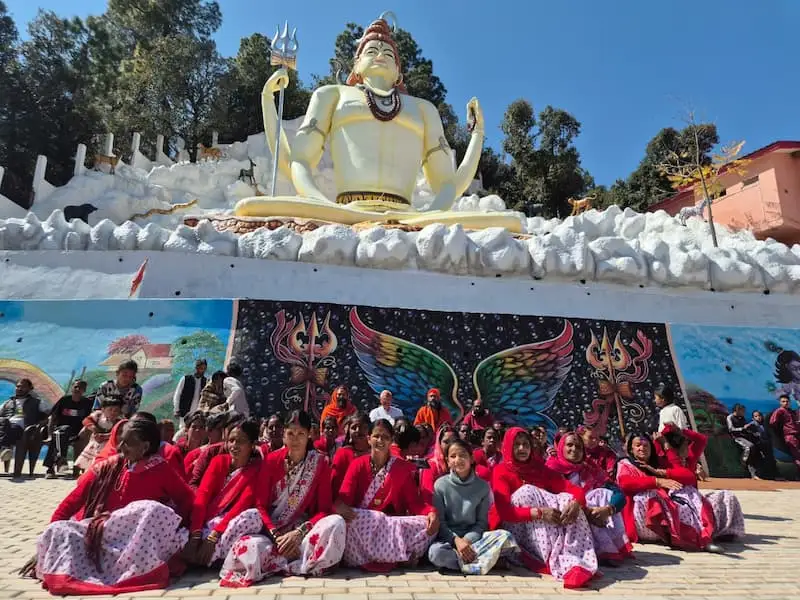 A large group gathered on the ashram grounds during a community programme