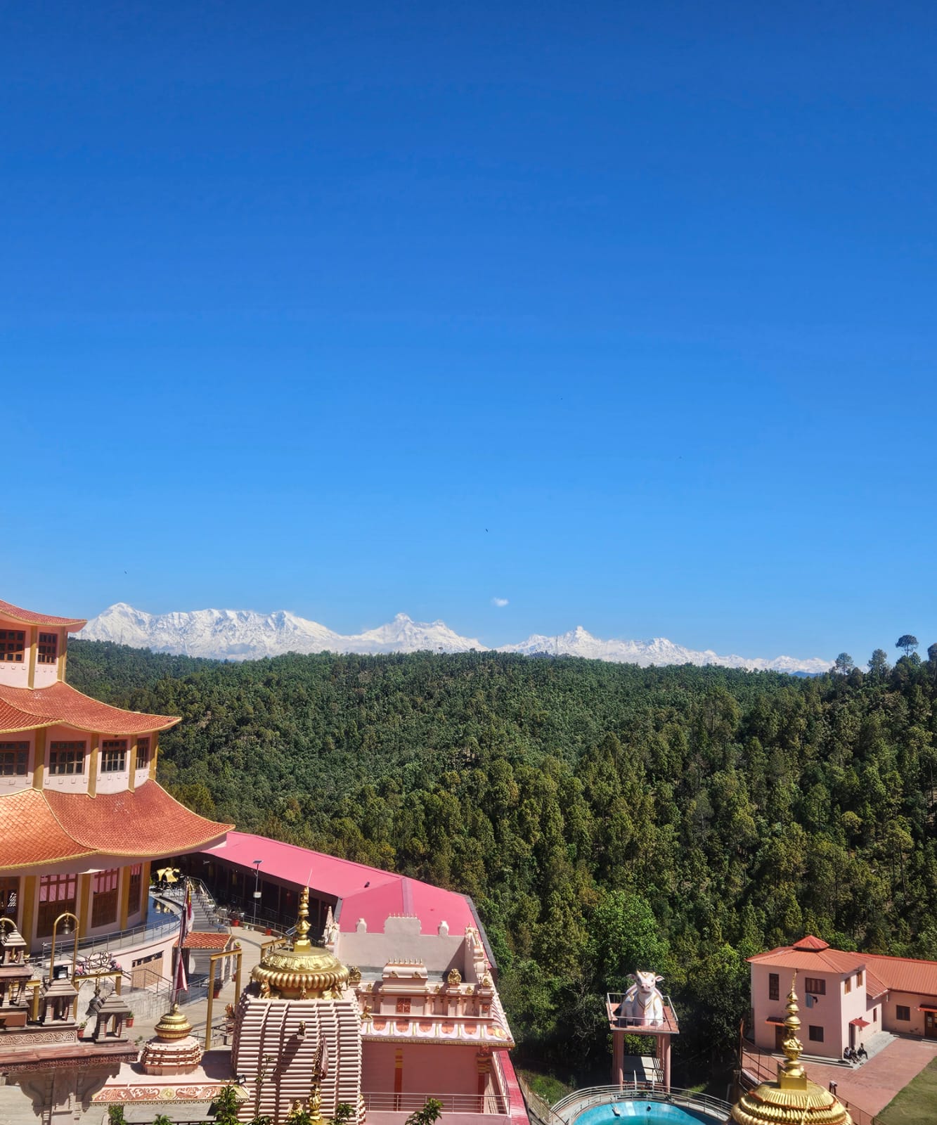 The ashram temple complex with the snow line of the greater Himalaya on the horizon